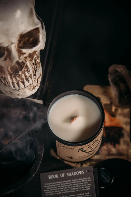 Hex and Wax candle Book of Shadows sitting next to story card