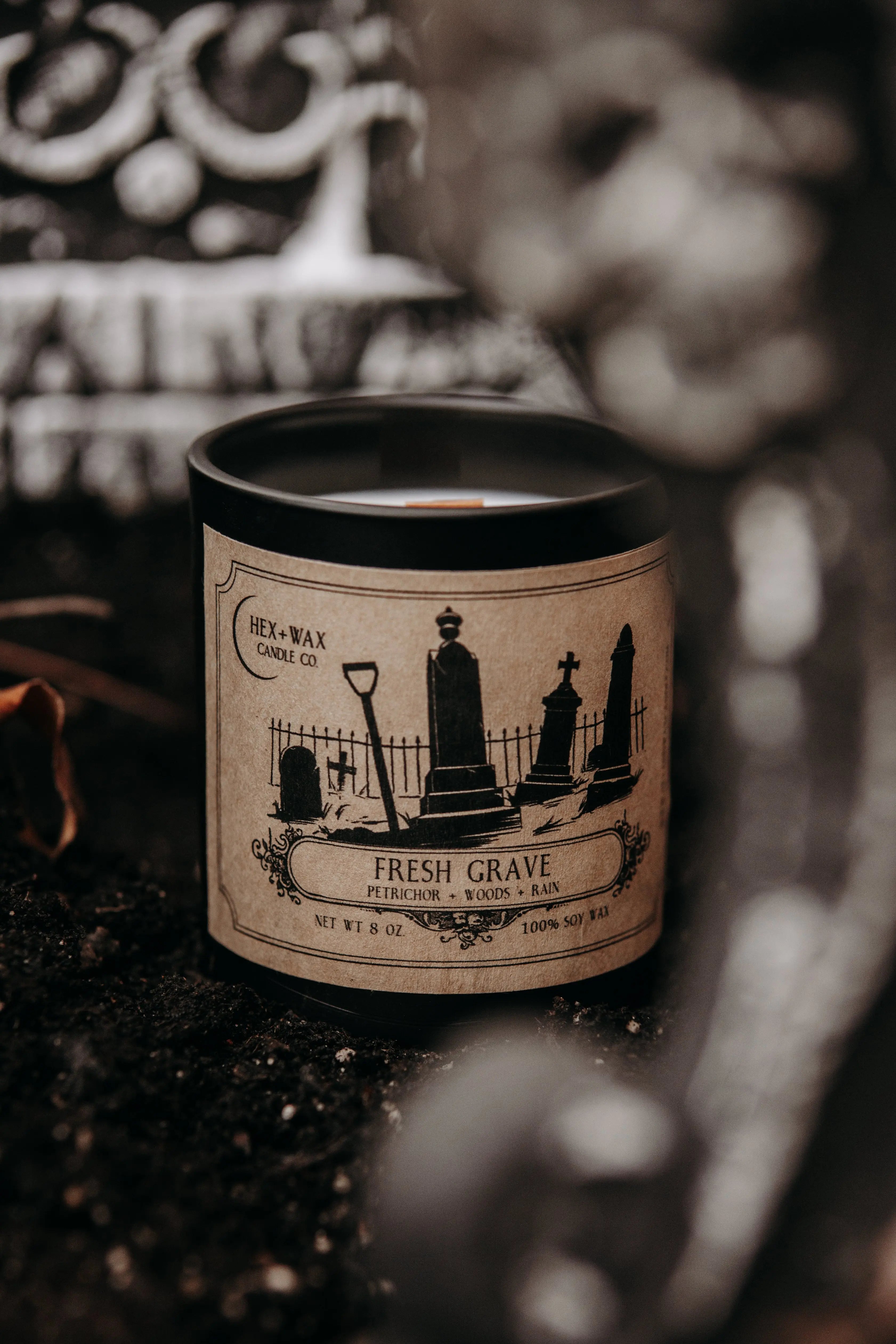 Hex and Wax horror candle with flickering flame casting shadows