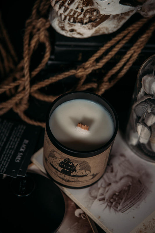 black sails sitting atop a stack of old photographs