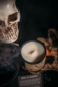 Load image into Gallery viewer, Hex and Wax candle Book of Shadows sitting next to story card
