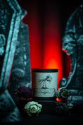 Load image into Gallery viewer, Til death do us part candle nestled between gravestones
